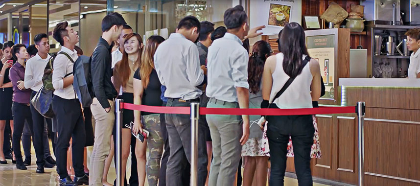 Long queue of office workers waiting to buy some beverages at a retail outlet